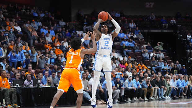 Nov 21, 2021; Uncasville, CT, USA; North Carolina Tarheels guard Caleb Love (2) shoots a three point jump shot with Tennessee Volunteers guard Kennedy Chandler (1) defending during the first half at Mohegan Sun Arena. Mandatory Credit: Gregory Fisher-USA TODAY Sports